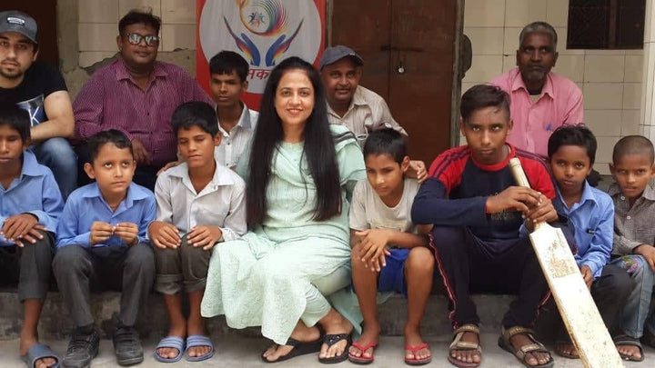Shubhkarman volunteers seated with a group of children in Delhi